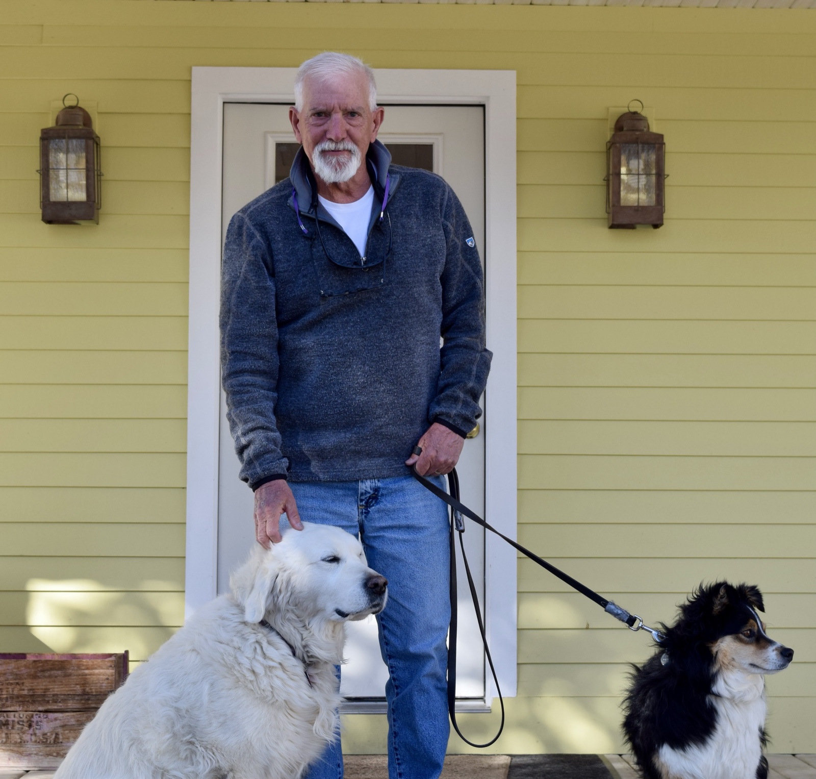 Martin J. Smith with his dogs on his front porch in Grand County, Colorado